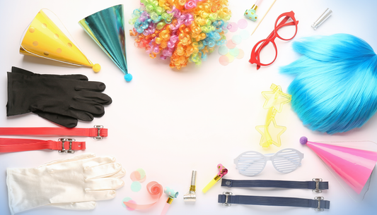 Colourful fancy-dress hats, wigs, gloves, braces, glasses and party accessories arranged for a Labreeze style guide
